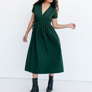 Wrap dress in emerald green. Retails for $175